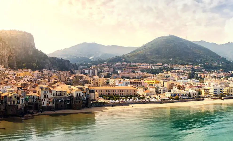 Italian coastline town with mountain backdrop